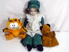 Vintage Toys - a vintage Chad Valley Sooty puppet, a Garfield and a bisque headed doll,