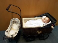 Two quality reproduction doll's prams, one with wicker body, metal wheels and wooden handle,