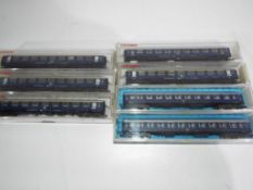 Fleischmann and Roco N gauge - seven passenger carriages, maroon and cream livery,