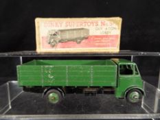 Dinky Supertoys - A boxed Dinky Supertoys #511 Guy 4 - Ton Lorry in green with black chassis,