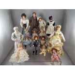 Dolls House Accessories - a collection of fourteen ceramic faced dressed dolls to include adults