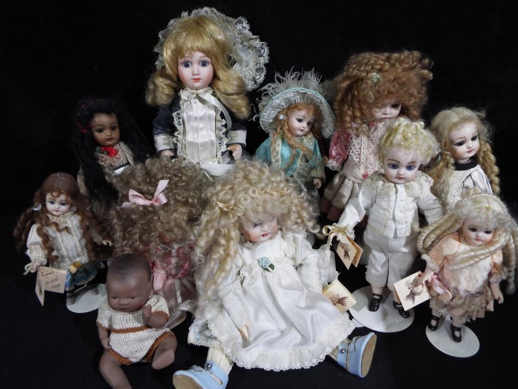 Dolls - a collection of six Little Heirloom ceramic faced dolls ranging in size from 24 cm to 13 cm