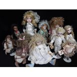 Dolls - a collection of six Little Heirloom ceramic faced dolls ranging in size from 24 cm to 13 cm