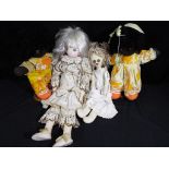A collection of four good quality cloth dolls two with stands (4)