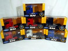 Diecast - seven 1:32 scale diecast trucks by Welly, includes two x MAN TGX in blue and red,