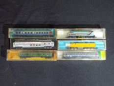 Model Railways - Atlas, Model Power and others - two diesel locomotives and four coaches,