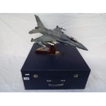 A model fighter plane on stand, F16 Fighting Falcon, wingspan 34 cm, with paper label 'Fighter' U.A.