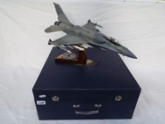 A model fighter plane on stand, F16 Fighting Falcon, wingspan 34 cm, with paper label 'Fighter' U.A.
