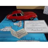 Franklin Mint - a boxed 1:24 scale 1961 Jaguar XK E Type in Red with related ephemera and