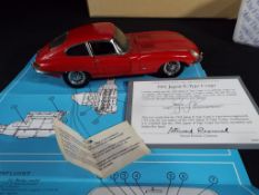 Franklin Mint - a boxed 1:24 scale 1961 Jaguar XK E Type in Red with related ephemera and