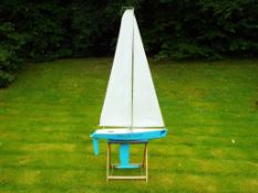 A wooden pond yacht, named Special Lady, battery powered on stand, approximately 177 cm height,