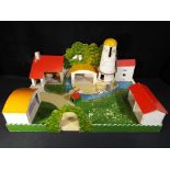 A kit made model farm in a need of restoration measuring approximately 62 cm x 40 cm x 32 cm.