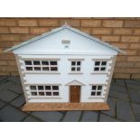 A wooden dolls house with accessories measuring approximately 57 cm x 72 cm x 38 cm.