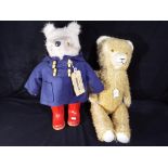 A Paddington bear, blue coat, red wellies,