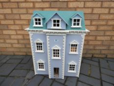 Dolls House - a wooden three storey dolls house with furniture