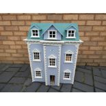 Dolls House - a wooden three storey dolls house with furniture