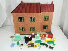 A two storey wooden dolls house with lights fitted, but untested,