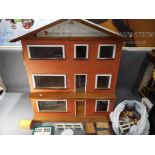 A wooden three story dolls house with accessories, approximately 75 cm x 73 cm x 41 cm.