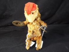 A mid century clockwork automaton toy monkey / chimp playing the cymbals with key approx 19cm (h).