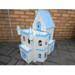 A wooden dolls house with accessories in the form of a castle, approximately 70 cm x 59 cm x 30 cm.