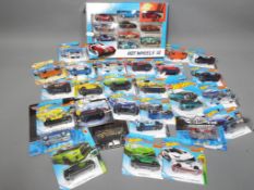 Diecast Vehicles - a collection of 27 single Hot Wheel cars in blister packs,