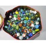 Marbles - A vintage tin containing a quantity of vintage marbles, approximately 200 in total.