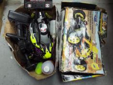 A collection of two gas powered remote controlled cars to include a Hot Bodies car,