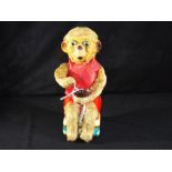 Cragston Japanese unboxed battery operated tin plate monkey,