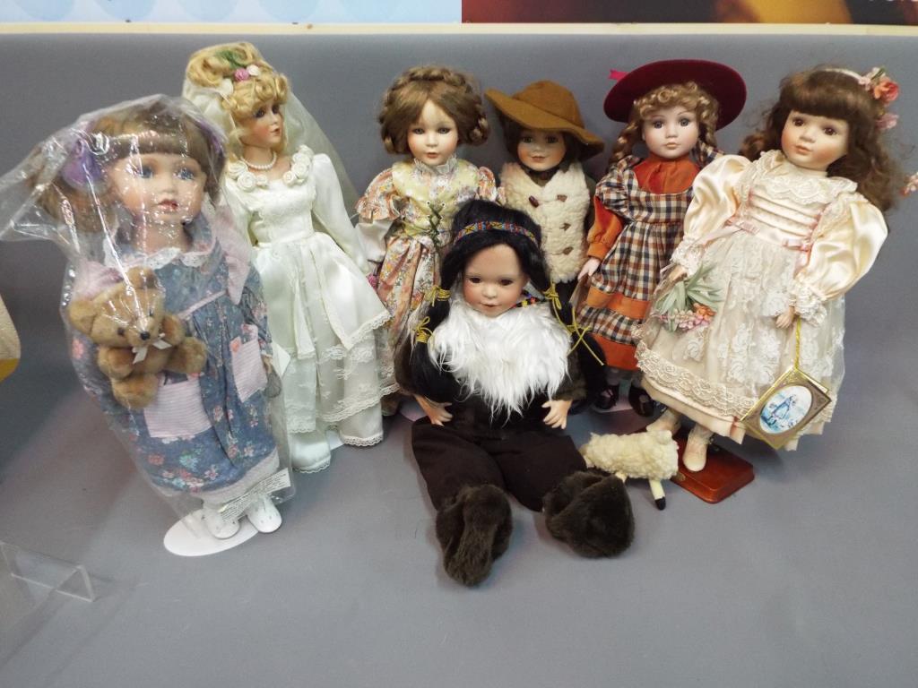 A collection of seven contemporary porcelain faced Collector's dolls, some boxed.