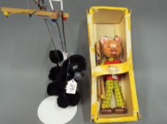 Pelham Puppets - a Pelham Rupert The Bear puppet with box and a Pelham Black Puddle puppet with red