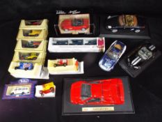 Maisto, Matchbox and others - 14 predominately boxed diecast model vehicles in various scales.