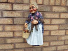 A marionette in the form of an aged woman,