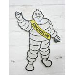 A wall hanging cast iron Michelin man
