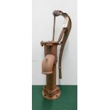 A large cast iron rusty garden pump ornament