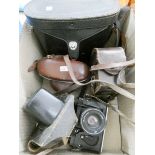 An old cine camera in carrying case, a pair of old binoculars in carrying case,