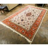 A cream and pattered Persian design wool pile rug approx 12' x 7'6