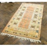 A cream and patterned Persian wool pile rug 80" x 47"