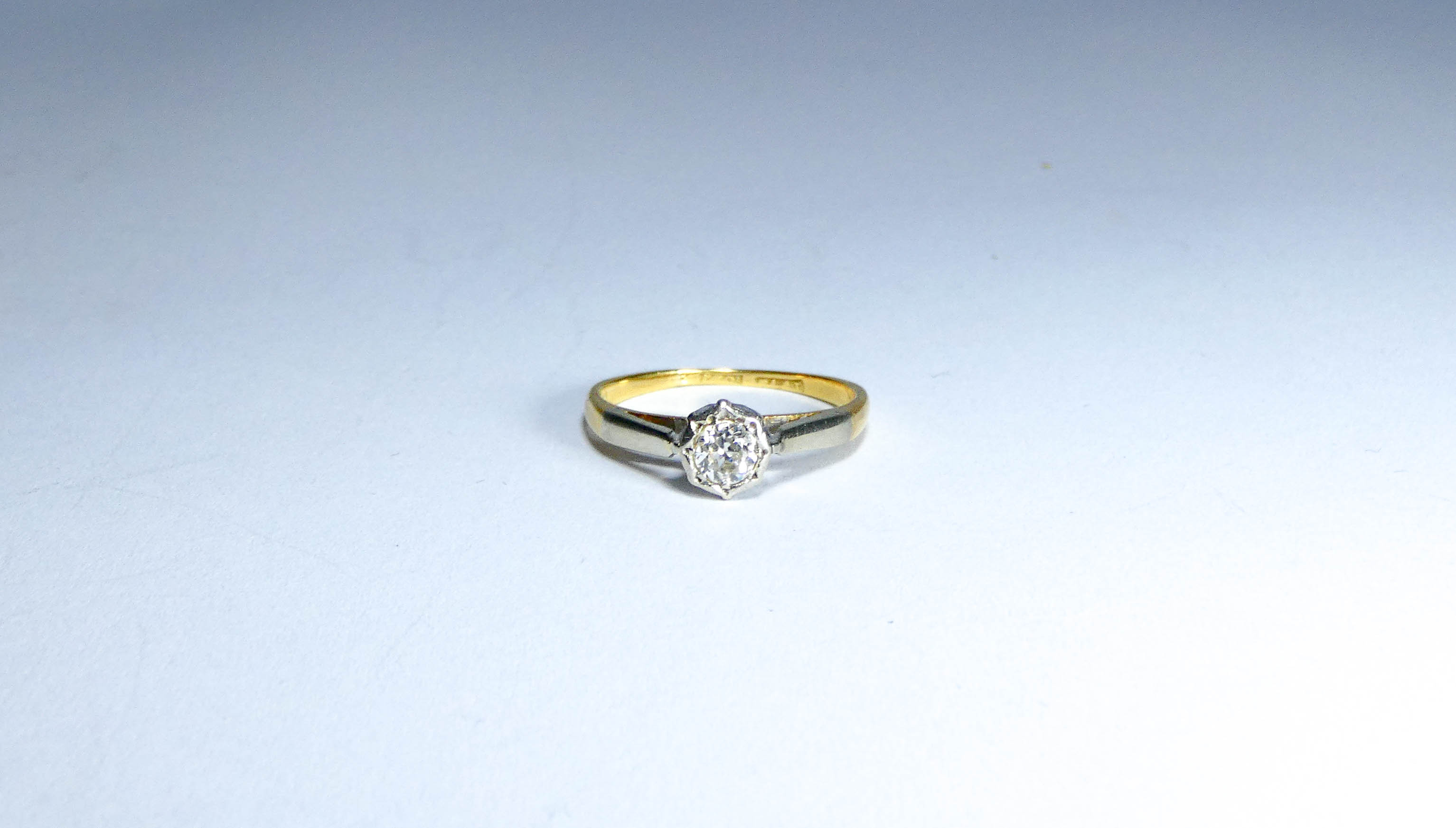 18ct and platinum mounted solitaire diamond ring, ring size K It weighs 2g.