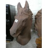 A large rusty cast iron horses head bust