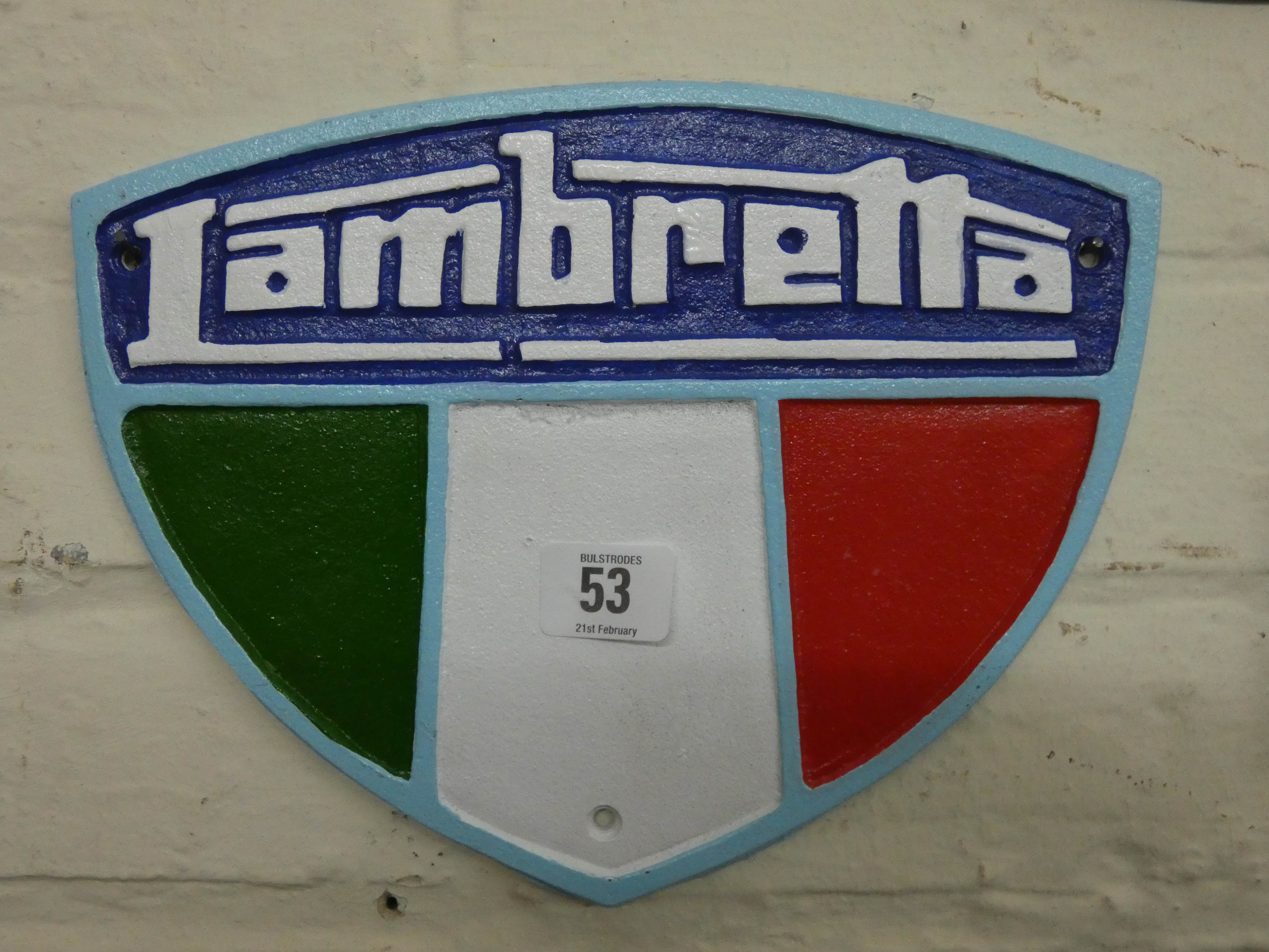 A cast iron wall hanging Lambretta shield shaped plaque