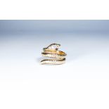 9ct gold coiled snake design dress ring, the head set with garnet eyes.
