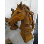 A large cast iron horses head on a ball