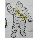 A Michelin man shaped cast iron plaque