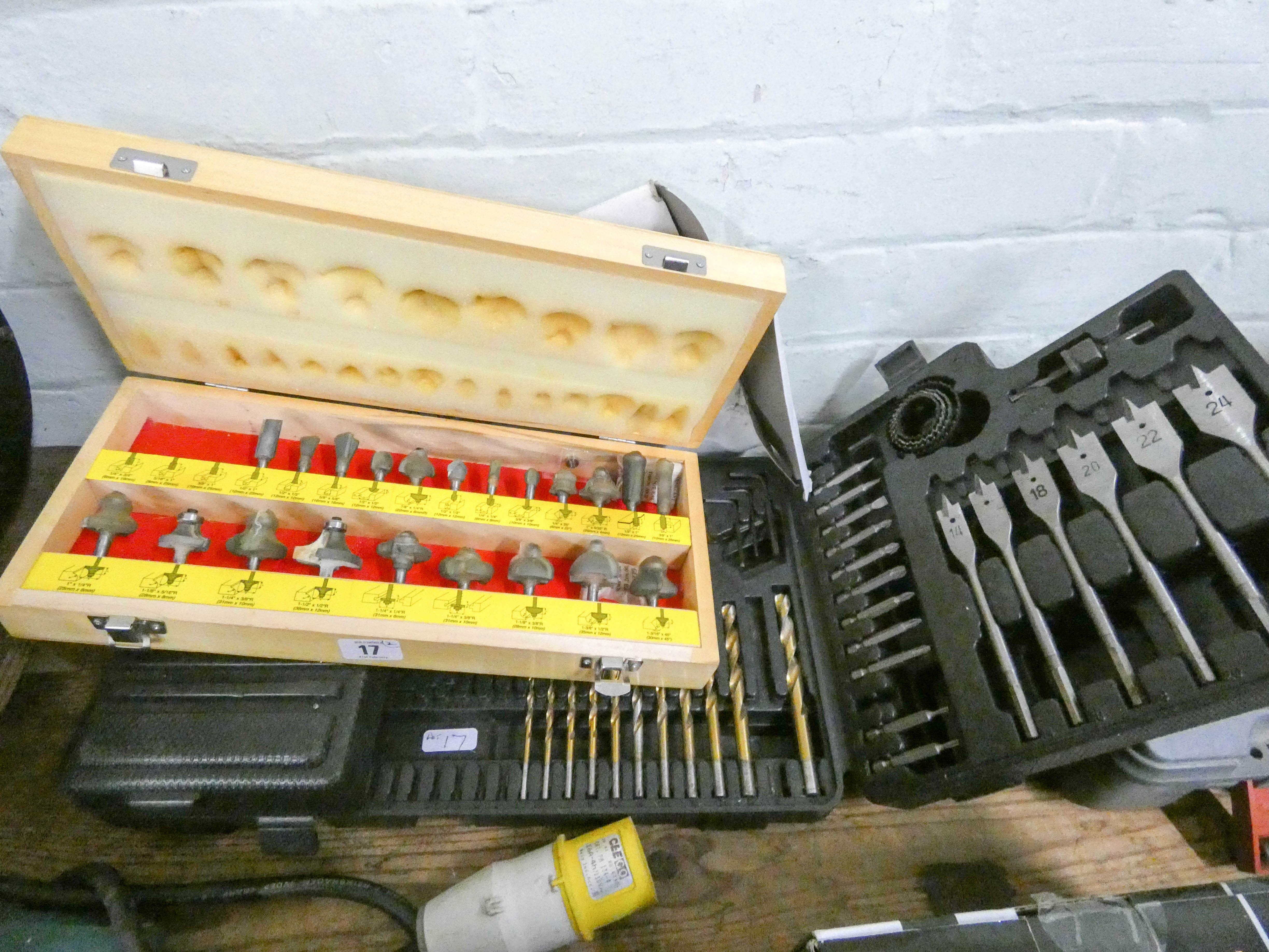 A comprehensive drill bit set and a screw fix router fit set in wooden carrying case