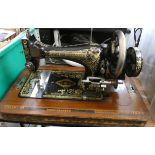 A Frister and Rossmann old sewing machine in wooden carrying case