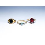 Three 9ct gold ladies dress rings, set with onyx, garnet and blue stone.
