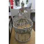 An ornate bird cage style candle holder
