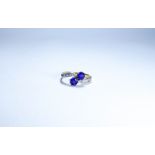 Amethyst and diamond ring, set two circular amethysts in a cross over design, shank stamped 18,