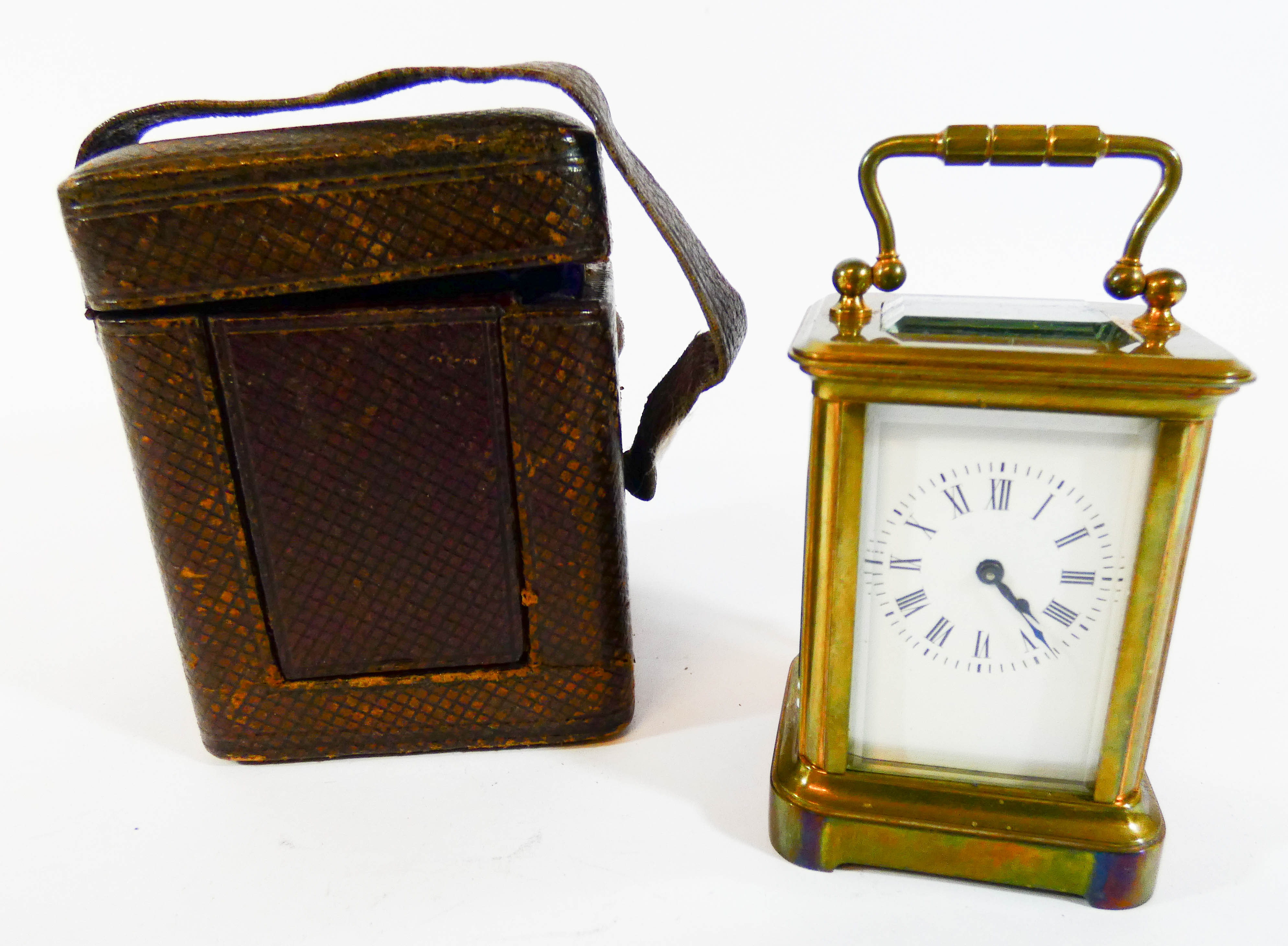 A miniature gilt brass carriage clock with leather travelling case, height with the handle up 9.