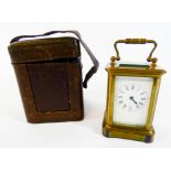 A miniature gilt brass carriage clock with leather travelling case, height with the handle up 9.